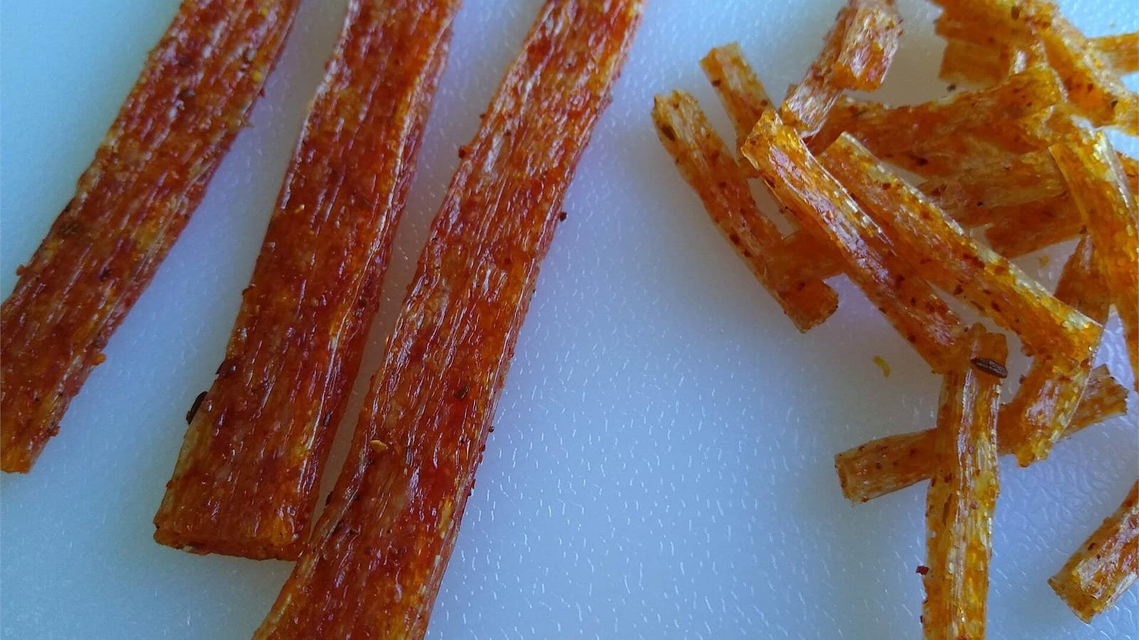 Glossy red latiao strips and smaller cut pieces shown up close on a light background